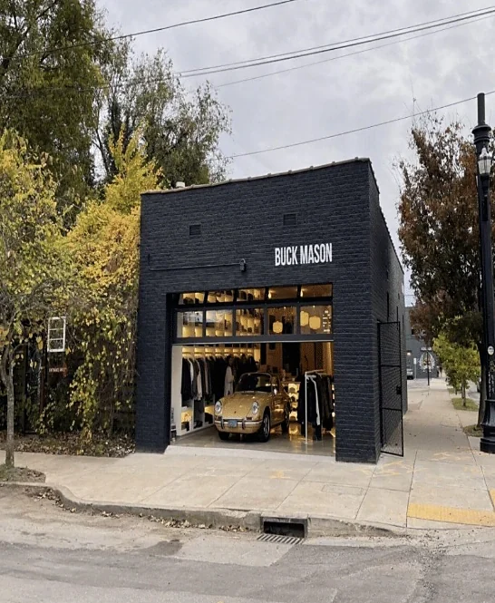 Black brick single-storey store open to the street
