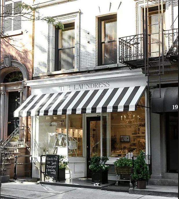 Awning-shaded shopfront on a townhouse block
